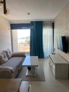 a living room with a couch and a tv at Elia in Bečići