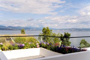 a balcony with flowers and a view of the water at 大理洱畔民宿 in Dali
