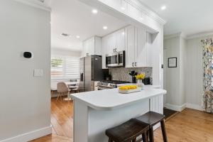 a kitchen with white cabinets and a white counter top at Sea Renity - 4333 Twelfth Street in Saint Simons Island