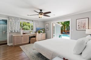 a bedroom with a bed and a desk and a window at Sea Renity - 4333 Twelfth Street in Saint Simons Island +25 photos