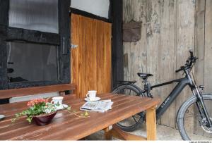 a bike parked next to a wooden table with a table sidx sidx at BeiArnold in Schleiden