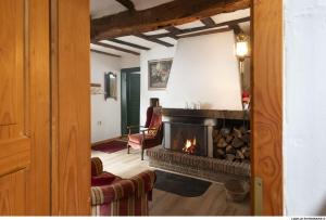 a living room with a fireplace and a couch at BeiArnold in Schleiden