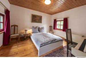a bedroom with a bed and a table in it at BeiArnold in Schleiden