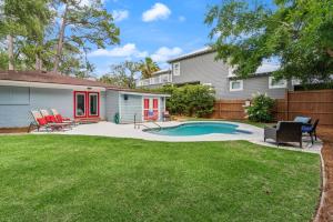 a backyard with a swimming pool and a house at Sea Renity - 4333 Twelfth Street in Saint Simons Island
