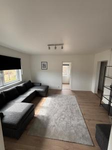 a living room with a couch and a rug at High Coast Stay Floor 2 in Ramvik