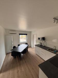 a kitchen and dining room with a table and chairs at High Coast Stay Floor 2 in Ramvik