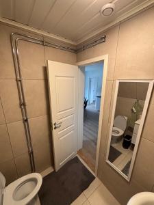 a bathroom with two toilets and a mirror at High Coast Stay Floor 2 in Ramvik +13 photos