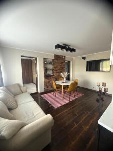a living room with a couch and a table at Hubane korter järve kaldal in Värska
