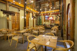 a restaurant with tables and chairs in a room at Delgadillo Boutique Hotel by Socialtel in Bogotá