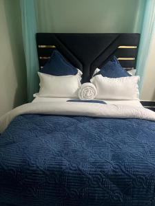 a blue and white bed with blue and white pillows at Sylvan hotel in Kasangati