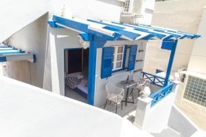 an overhead view of a blue and white house with a table and chairs at Lunar Seaside Hotel in Perissa