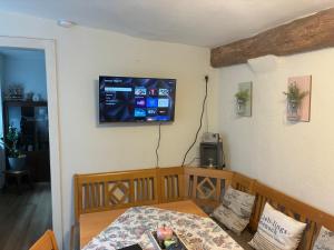 a room with a bed and a television on the wall at Haus Ewald in Enkirch