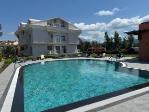 a large swimming pool in front of a building at Defne Beach Makri in Fethiye