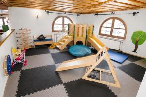 a childrens play room with a slide and play equipment at Familotel Der Böhmerwald in Eschlkam