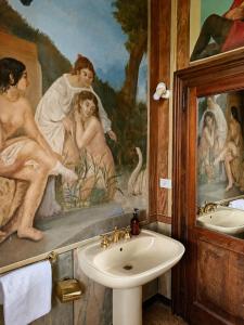 a bathroom with a sink and a painting on the wall at Lake House by Veneto Villa in Albignasego