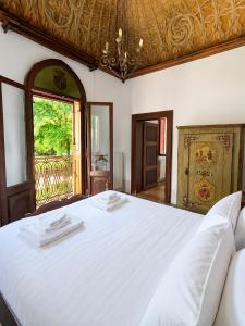 a bedroom with a large white bed and a window at Lake House by Veneto Villa in Albignasego