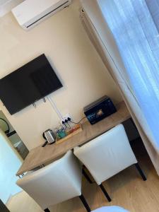 a room with a desk with a tv and a chair at Nvivi boutique hotel in Polokwane