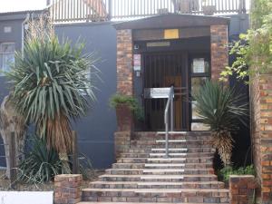 a brick staircase leading to a building with a door at Klawer Hotel in Klawer