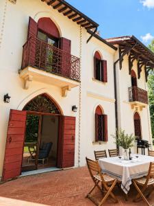 a patio with a table and chairs in front of a house at Lake House by Veneto Villa in Albignasego