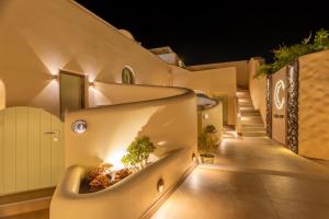 an exterior view of a house with a staircase with lights at Casita Suites in Megalochori
