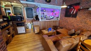 a living room with a couch and a brick wall at Leecliff Guest House in Blackpool