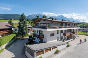 an aerial view of a building with mountains in the background at Echt Woods Appartements in Söll