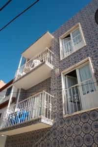 a building with white balconies on the side of it at D. Antonia in Peniche