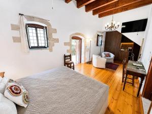 a bedroom with a bed and a desk in a room at Venetian Palace Chania - Adults Only in Chania