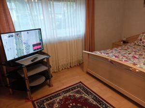 a bedroom with a bed and a computer on a table at Appartement Draublick in Unterpudlach