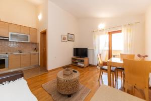 a living room with a kitchen and a dining room at Villa Zubčić in Zadar