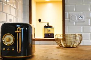 a toaster sitting on top of a wooden table at La Suite Enchantée in Valentigney