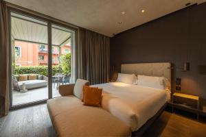 a bedroom with a large bed and a couch at Hotel VIU Milan, a Member of Design Hotels in Milan +103 photos