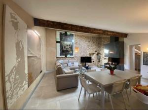 a living room with a couch and a table at La terrasse des oiseaux in Taillet