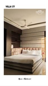 a bedroom with a large white bed in it at Villa 27 in Sonāpur