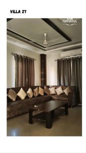 a living room with a couch and a coffee table at Villa 27 in Sonāpur