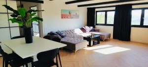 a living room with a couch and a table at Private Wellness Boa Vista in Vale da Certa
