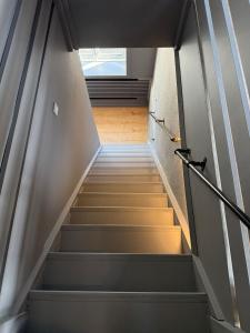 a staircase in a building with a window at 4SEASONS -- Emerald Summer Lounge in Aalborg +4 photos