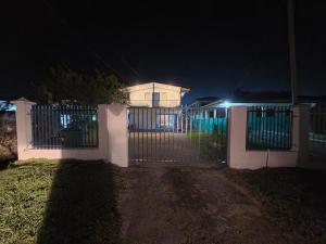 a gate in front of a house at night at BOU's Accomodation in Nadi +2 photos