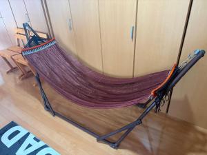 a hammock sitting on the floor in a room at Garden-View ゆふ in Yufu
