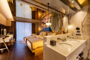 a hotel room with a bed and a bathroom with a sink at Merit Starlit Hotel & Residences in Budva +105 photos