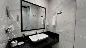 a bathroom with a sink and a mirror at Seven Rooms Boutique Hotel in Baku +16 photos