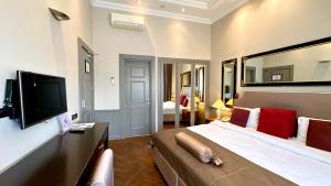 a hotel room with a large bed and a television at Seven Rooms Boutique Hotel in Baku