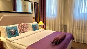a bedroom with a bed with a spider on it at Seven Rooms Boutique Hotel in Baku