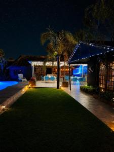 a backyard lit up at night with lights at The Guesthouse in Vanderbijlpark
