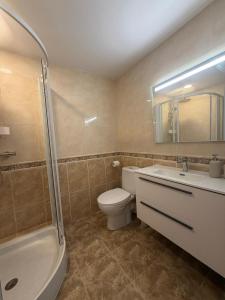a bathroom with a toilet and a sink and a shower at Tropical Salou in Salou