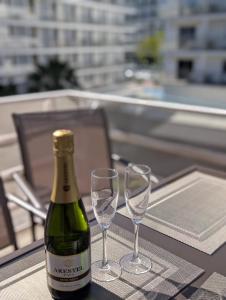 a bottle of champagne and two glasses on a table at Tropical Salou in Salou +15 photos