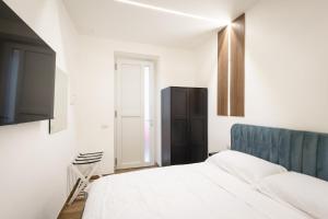 a white bedroom with a bed and a window at Azzurra Rooms Suite in Battipaglia +11 photos