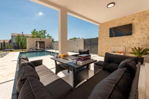 a living room with a couch and a table at Villa Flora Zadar Villas in Perušić Benkovački