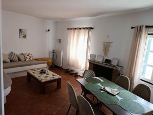a living room with a table and a couch at Villa Ioanna in Agkidia