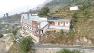 a house on the side of a hill at Hotel Radha Vallabh in Ukhimath